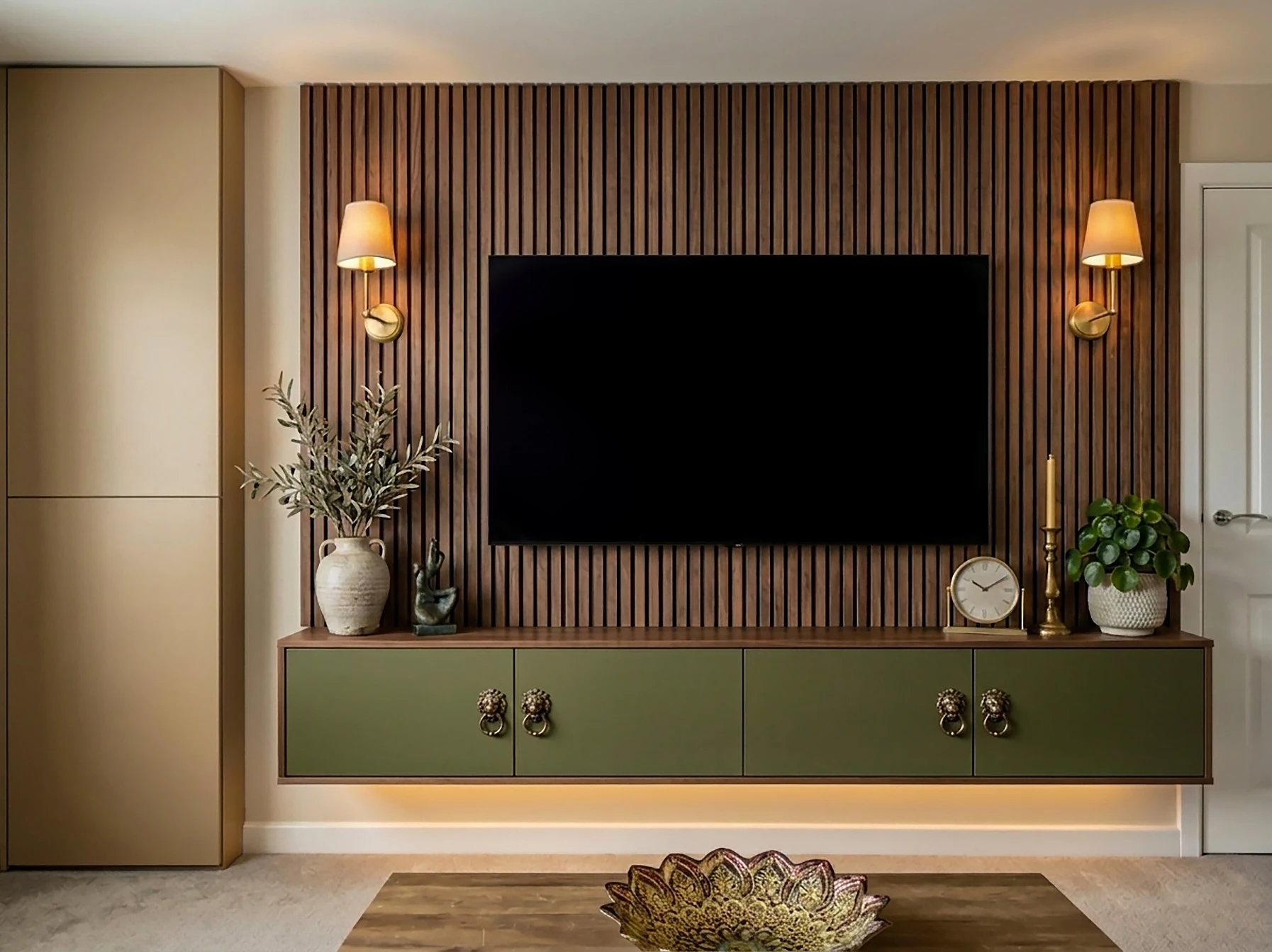 Custom sage green floating TV console with wooden wall sconces in a modern luxury living room designed by House of Ahana in Leeds.