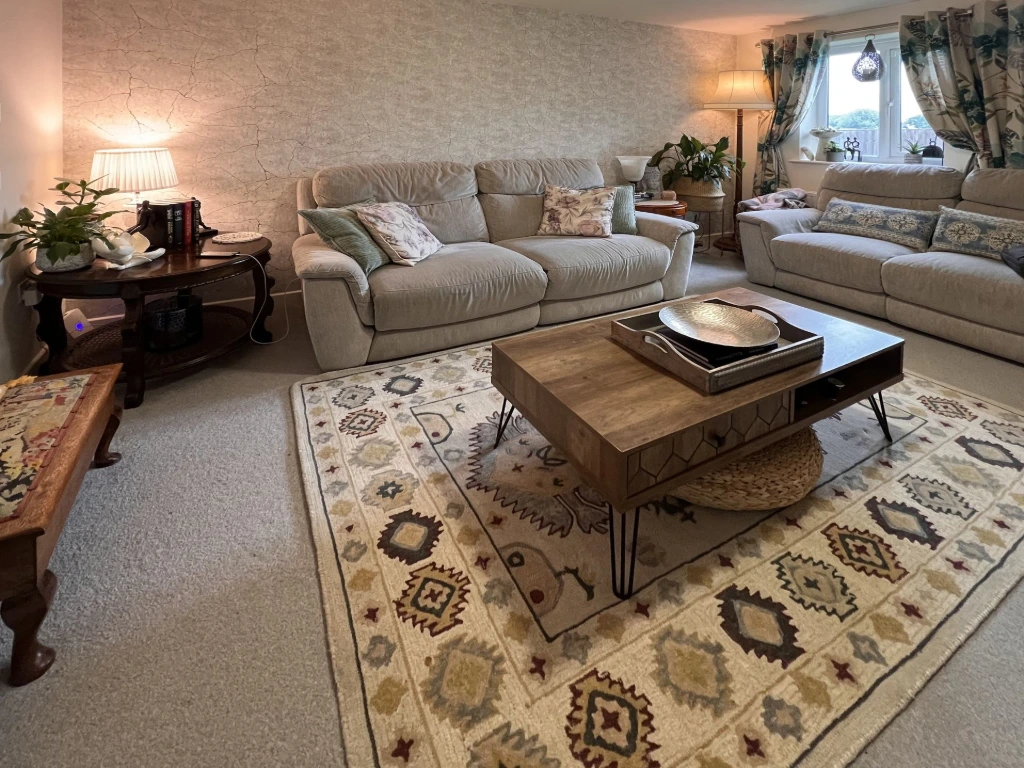 Luxury living room interior design by House of Ahana in Leeds Yorkshire UK featuring neutral sofas, wooden coffee table and patterned rug