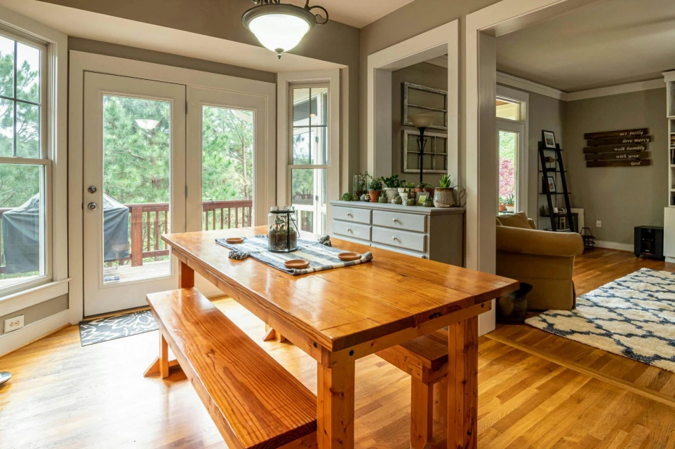 Modern dining area with wooden table, natural light and open interior layout in a Bradford UK home