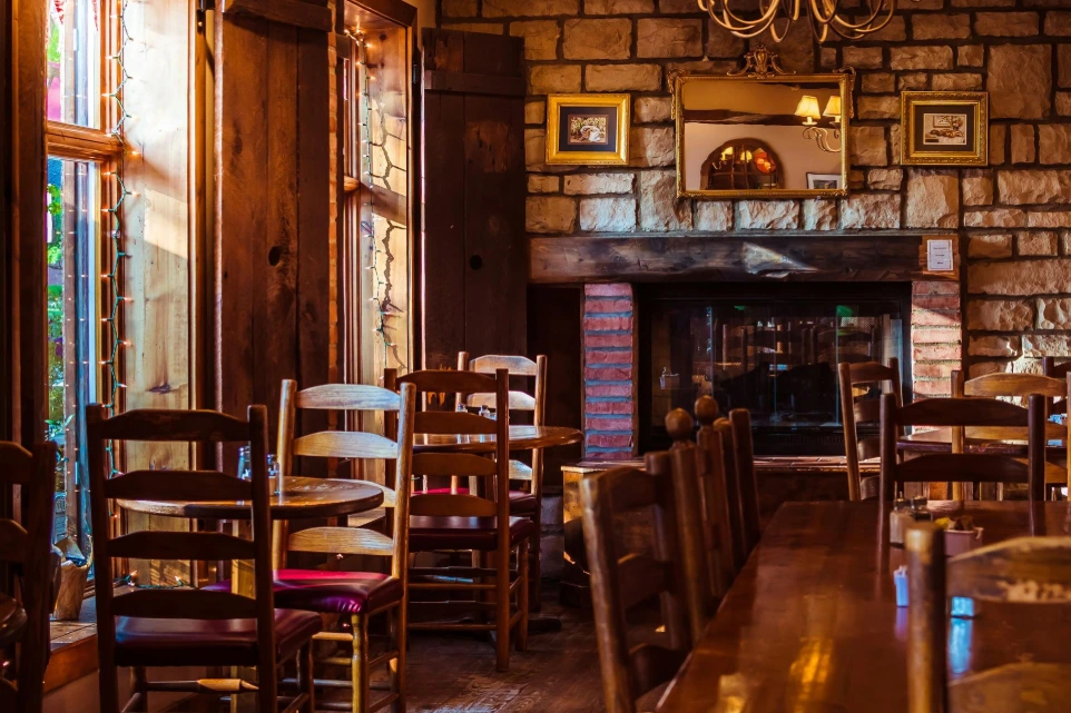 Boutique restaurant interior with wooden seating, fireplace and warm lighting in a Yorkshire UK setting