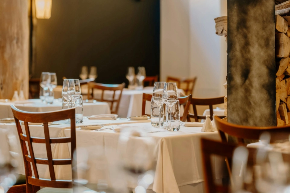 Fine dining restaurant interior with elegant table setting, wooden chairs and ambient lighting in a Leeds UK setting