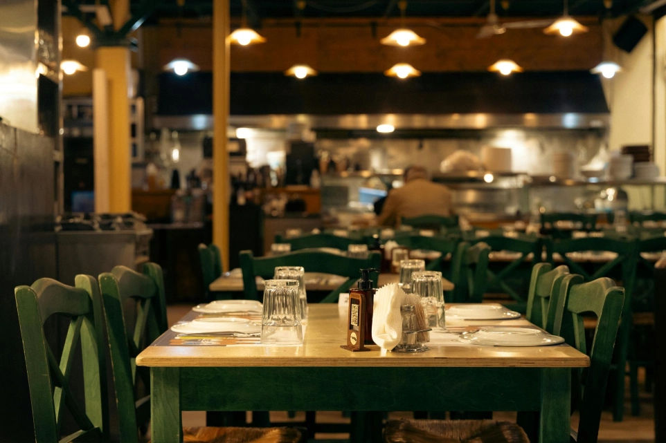 Cozy café interior with wooden tables, green chairs and warm ambient lighting in a Manchester UK setting
