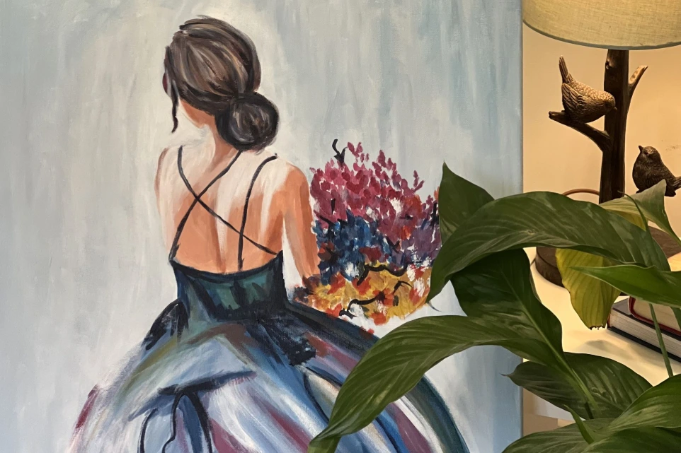 Custom hand-painted canvas artwork of a woman holding flowers, designed to enhance interior styling in UK homes