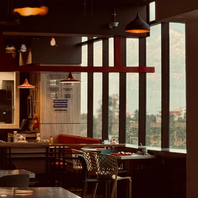 Cozy modern restaurant interior design with warm lighting and seating layout by commercial interior designers in the UK