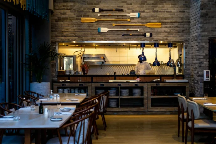 Commercial interior design for restaurant and hospitality space with warm lighting and wooden finishes